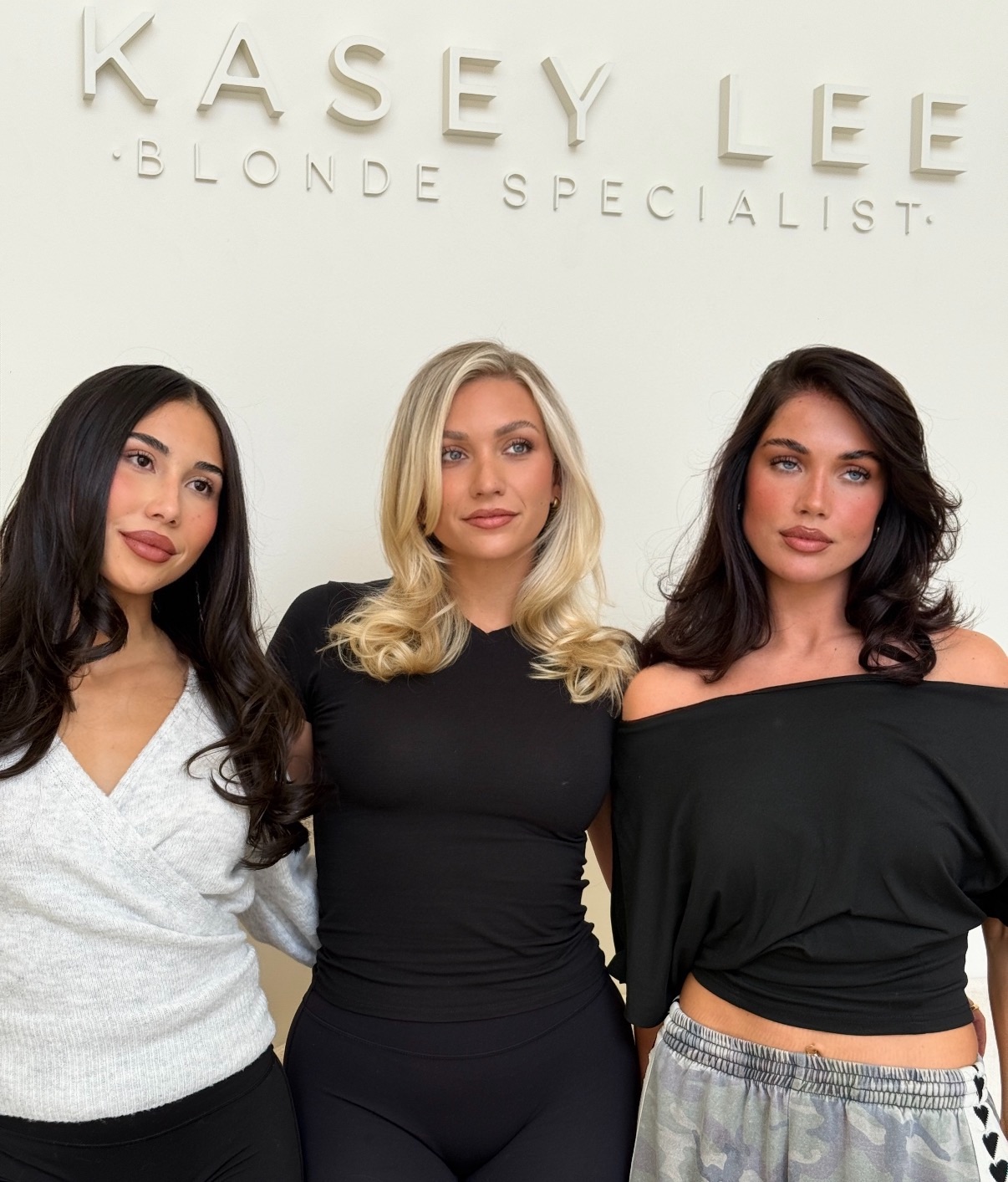 Wavy long blonde hair styled to the side, featuring the Platinum Blonde Service by blonde hairdresser in Melbourne.