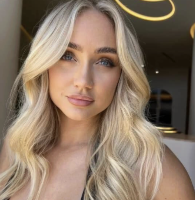 Wavy long blonde hair styled to the side, featuring the Platinum Blonde Service by blonde hairdresser in Melbourne.