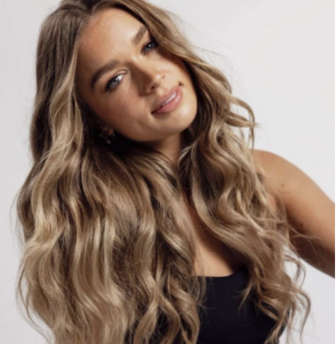 Wavy long blonde hair styled to the side, featuring the Platinum Blonde Service by blonde hairdresser in Melbourne.